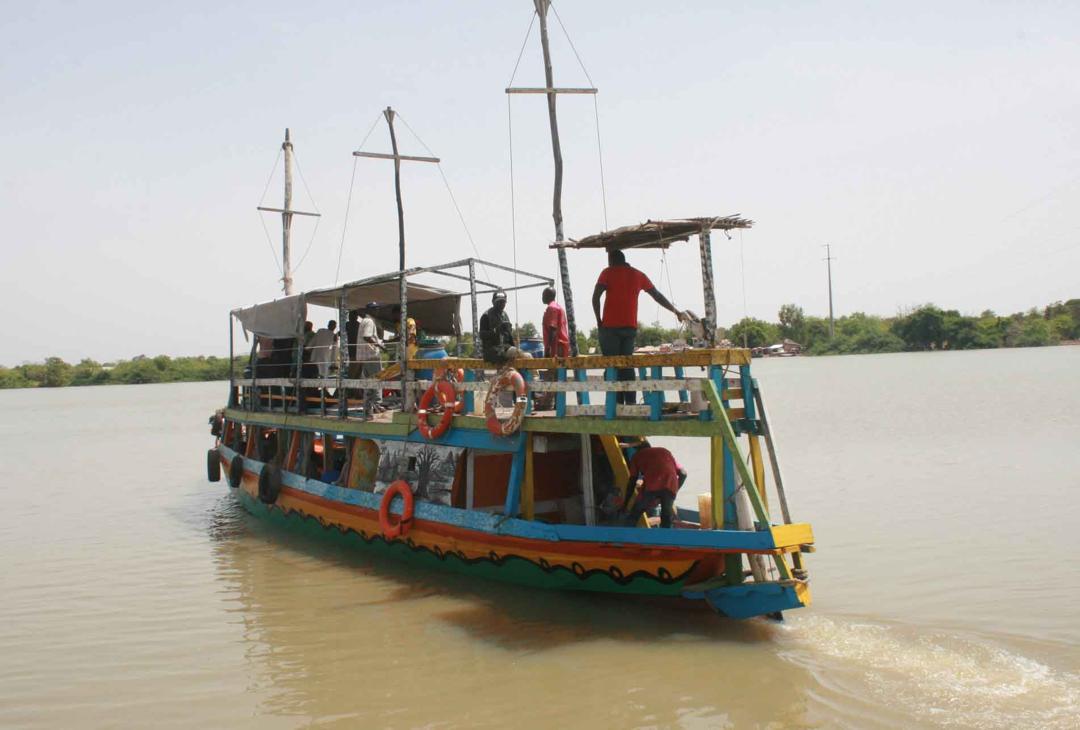 Traditional excursion boat cruising on the River Gambia