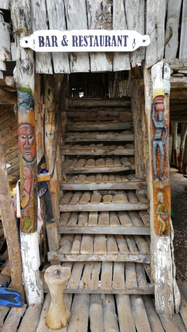 Rustic wooden entrance to the Lamin Lodge bar and restaurant